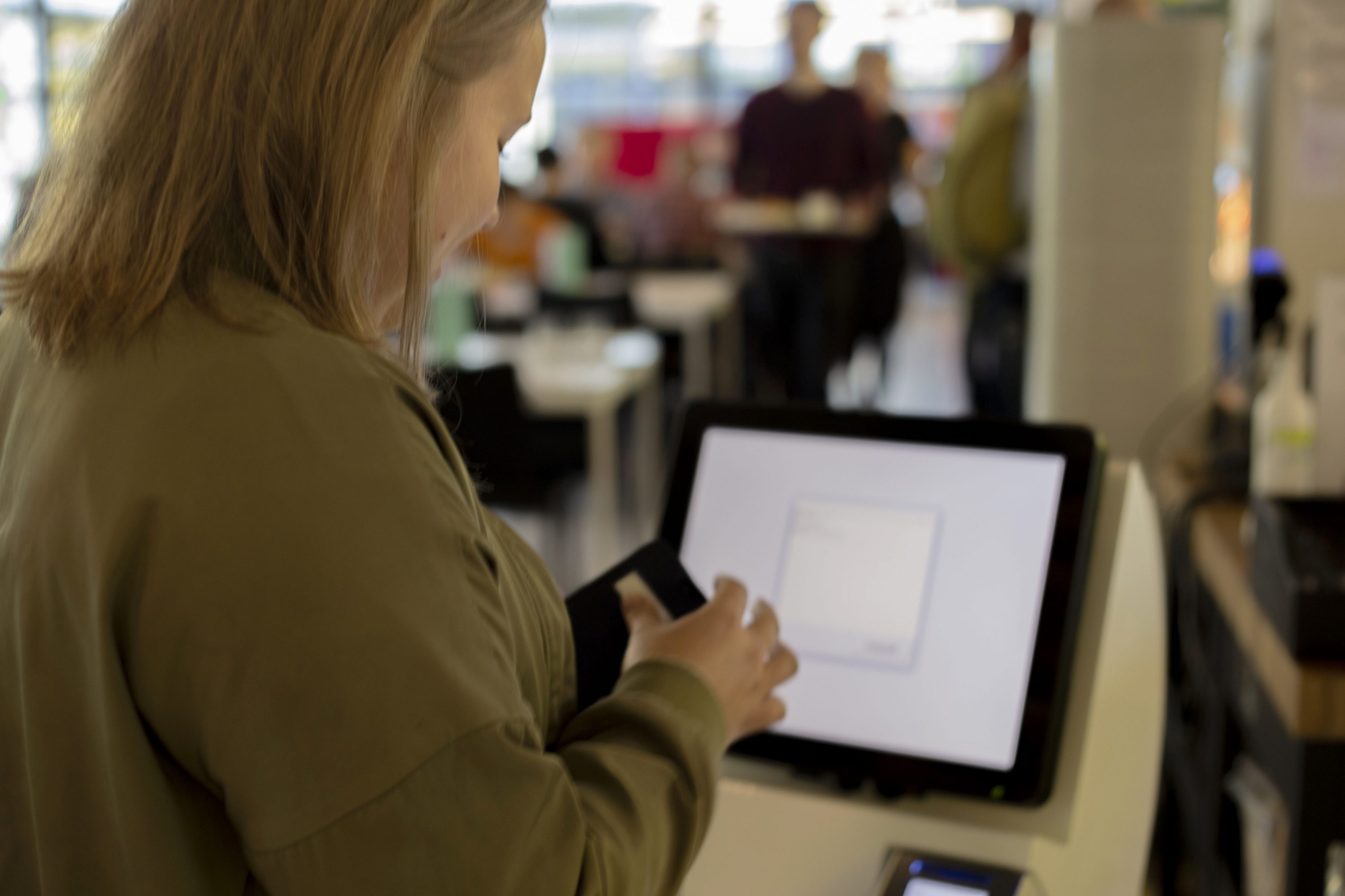 Cultural anthropology student Salla Marjakangas operates the self-checkout at restaurant Foobar on August 27. She found the menus of the counter a bit confusing at first.