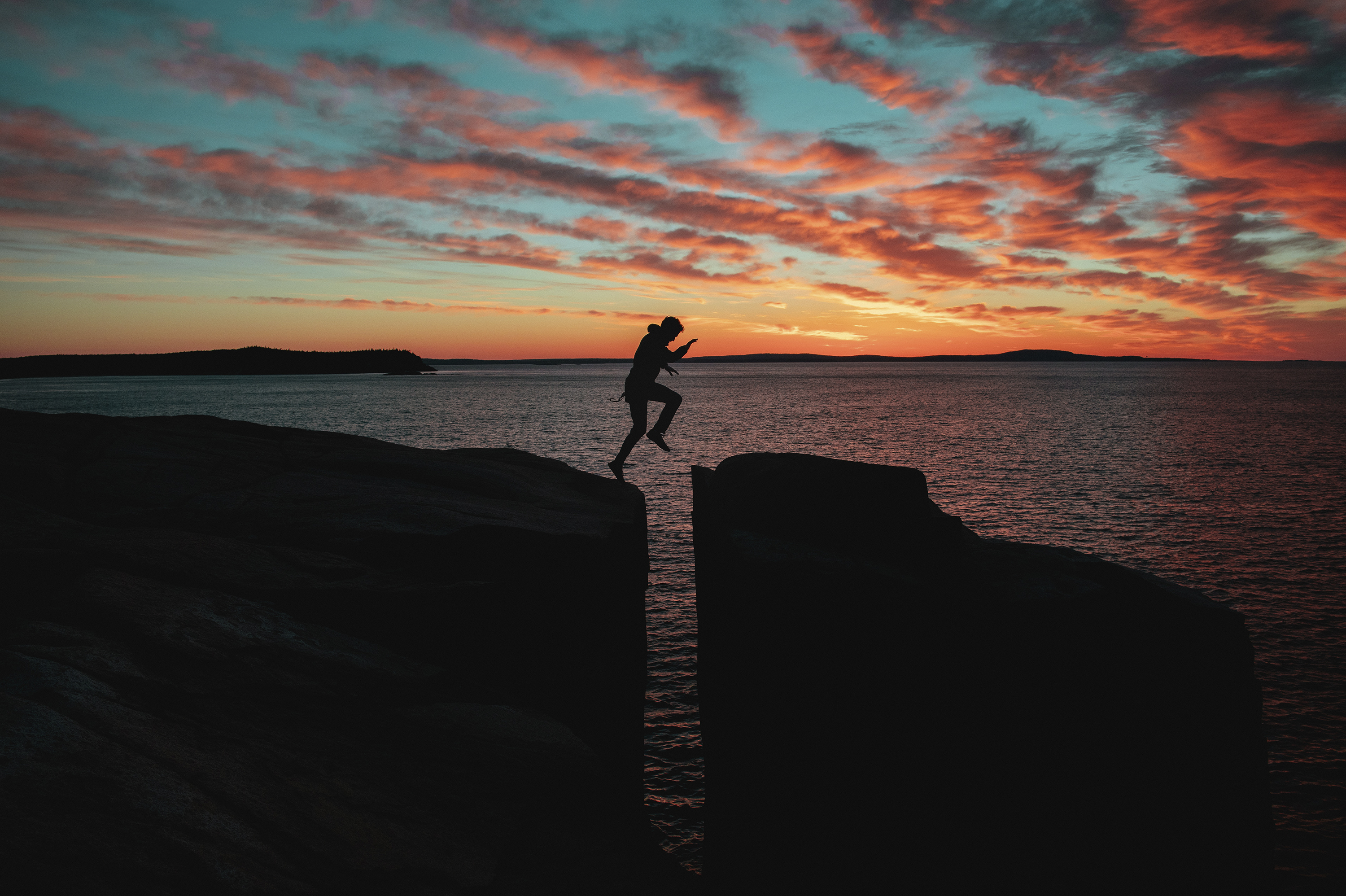 Man jumping over a cliff.