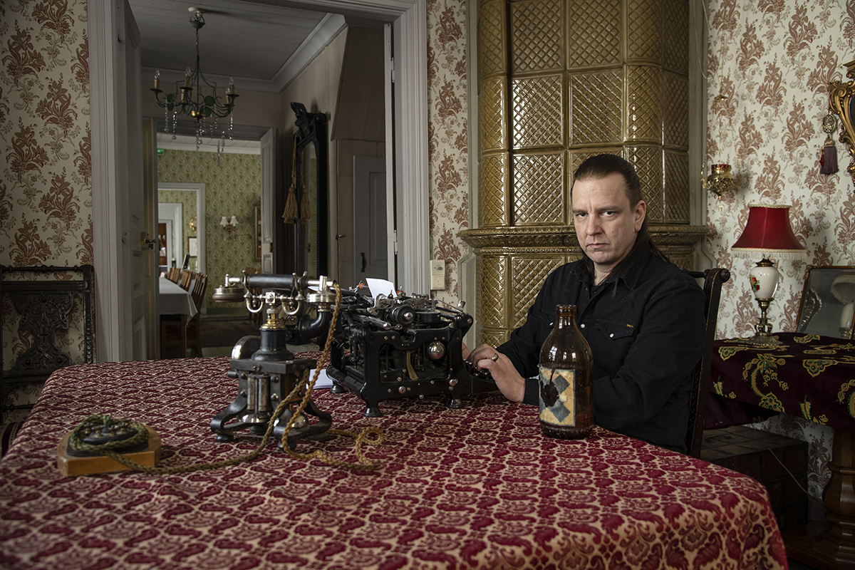 Sami Lopakka sitting at a desk with a typewriter